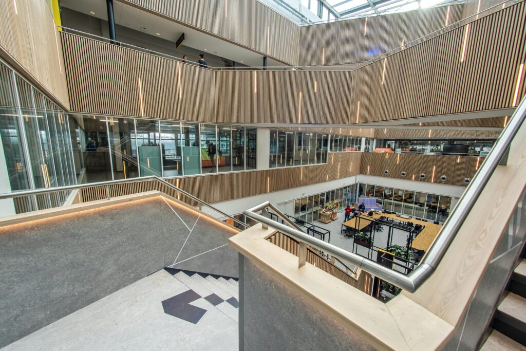 A spacious and modern office interior with sleek design and open staircases.